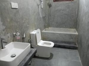 a bathroom with a sink and a toilet and a tub at Mariya Villa in Unawatuna