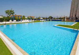 a large swimming pool with blue water in a resort at Nahariya SEA VIEW, Ha-aliya in Nahariyya