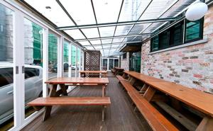 a row of wooden benches sitting on a porch at Daecheon sinhwa pension in Boryeong +1 photo