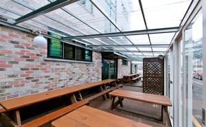 a room with benches and a brick wall at Daecheon sinhwa pension in Boryeong