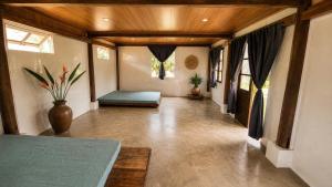 a large room with a bed and a couch at BângGlamping in Hue
