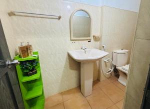 a bathroom with a sink and a toilet at The Beach House , Nilaveli , Trincomalee in Trincomalee +107 photos