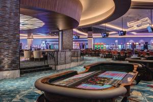 a casino with a poker table in the middle at Choctaw Casino & Resort Durant, a Wyndham Grand Hotel in Durant