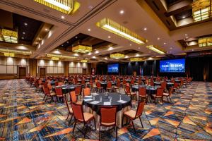 a large banquet hall with tables and chairs at Choctaw Casino & Resort Durant, a Wyndham Grand Hotel in Durant +151 photos