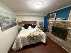 a bedroom with a bed and a fireplace at The Oasis in Clinton