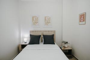 a bedroom with a large white bed with two tables at Casa Centro Kilkis in Kilkis