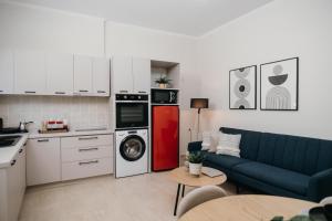 a kitchen with a blue couch and a red refrigerator at Casa Centro Kilkis in Kilkis