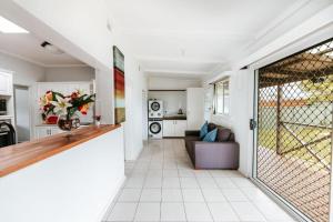 a living room with a door leading to a kitchen at Iconic Escape Nowra in Nowra