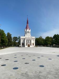 a building with a tower in the middle of a courtyard at S&A2 apartamentai in Panevėžys