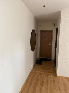 a hallway with a door and a mirror on a wall at S&A2 apartamentai in Panevėžys