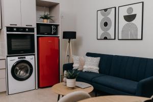 a living room with a blue couch and a red refrigerator at Casa Centro Kilkis in Kilkis +30 photos