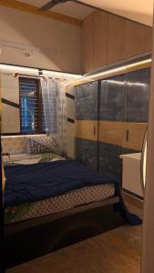 a bedroom with a bed in a room with a window at Yashaswi Hilldeck in Sondekoppa