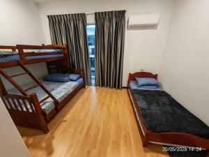 a bedroom with two bunk beds and a window at JN Villa Homestay 5 Bedroom house, Near Airport Kota Kinabalu in Donggongon
