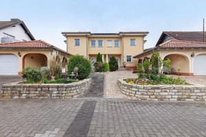 a house with a brick driveway in front of it at Villa am Keltenberg - La Stella in Glauburg