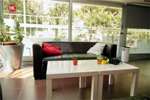 a living room with a black couch and a white table at Hotel Residence Key Club in Montalto di Castro