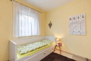 a bedroom with a bed with a window and a window at Villa am Keltenberg - La Stella in Glauburg