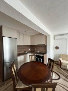 a kitchen with a table and chairs in a room at Apartmani MINA in Bar