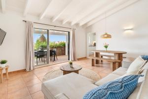 a living room with a couch and a table at Villas Menorca Sur by 3VILLAS in Son Bou