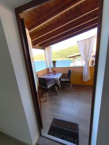 a view of a dining room with a table and chairs at Apartments and rooms Roberto B. in Valun