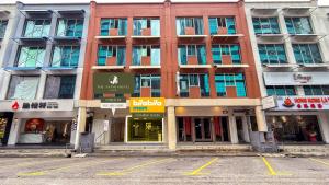 a building on a street with a parking lot at The Tapir Puchong by BYON Premium Suites & Hotels in Puchong