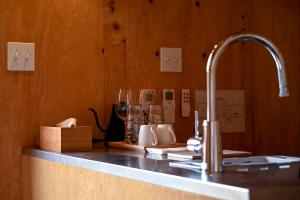 a kitchen counter with a sink and a faucet at anandahの宿 in Miyazaki