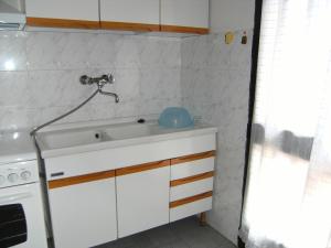 a kitchen with a sink and a stove at Viletta Pioppi in Lido delle Nazioni
