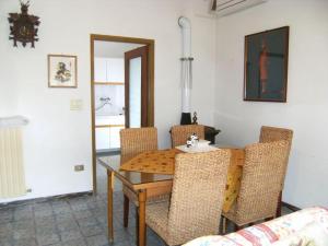 a dining room with a wooden table and chairs at Viletta Pioppi in Lido delle Nazioni +16 photos