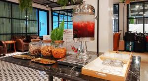 a counter with a drink in a blender on a table at Marwin Villa in Bangkok