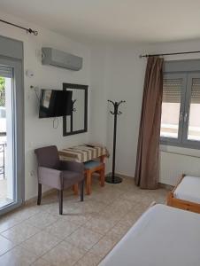 a bedroom with a bed and a desk and a chair at Pyrgos Sofokleous in Mytilene