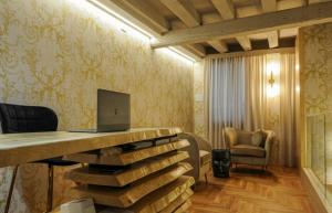 a room with a desk with a laptop on it at The Venice Nest @ Ca' Del Duca in Venice