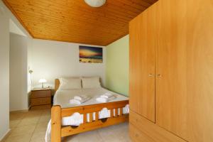 a bedroom with a bed with towels on it at Studio Liana in Frikes