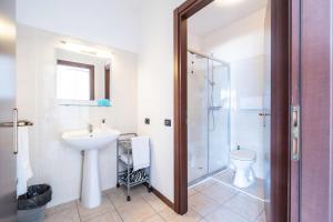 a bathroom with a sink and a shower and a toilet at Lake View Apartments in Acquaseria +157 photos