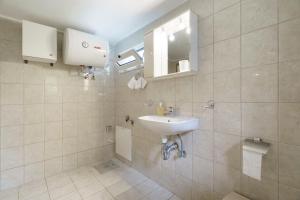 a bathroom with a sink and a mirror at Studio Liana in Frikes