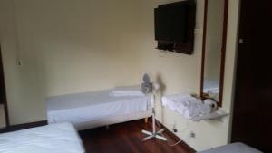 クリチバにあるHotel Piratiniの病室にはベッド2台と鏡が備わります。