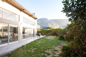 a house with a view of the mountains at Betty's Bay Cottage in Bettyʼs Bay