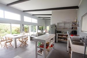 a kitchen with a table and a counter top at Betty's Bay Cottage in Bettyʼs Bay
