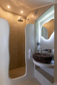 a bathroom with a sink and a mirror at Villa Karras - Sea & Mountain View in Perissa +24 photos