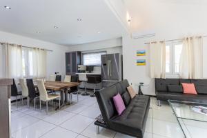 a living room with a table and a dining room at Mario's Kassiopi in Kassiopi
