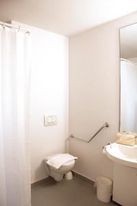 a bathroom with a toilet and a sink at ibis budget Bordeaux Sud in Villenave-dʼOrnon +17 photos