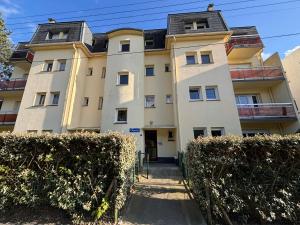 an apartment building with bushes in front of it at Studio de vacances Stella Plage in Cucq