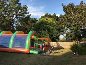 a child playing in a playground with a play structure at Camping Kost Ar Moor in Fouesnant