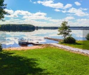 a view of a lake with a boat in the water at Paris Beach in Saarijärvi