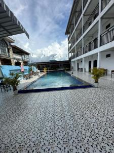a swimming pool in the middle of a building at Santara Hostel in Vang Vieng +16 photos