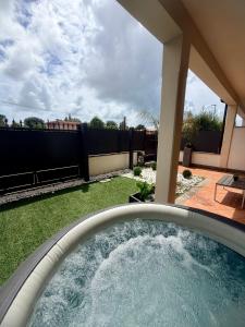 a backyard with a hot tub in a yard at VILLA SEASIDE HAVEN - Private Retreat with Garden in Anzio in Anzio