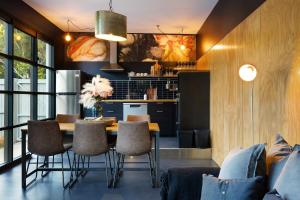 a kitchen and dining room with a table and chairs at Glenbrook Guest House in Ewingsdale