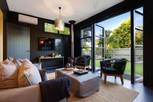 a living room with a couch and chairs at Glenbrook Guest House in Ewingsdale