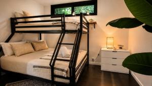 a black bunk bed in a room with a window at Glenbrook Guest House in Ewingsdale