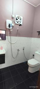 a bathroom with a toilet and a shower at IA Tiny House 2 in Dungun