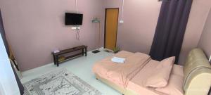 a hospital room with a bed and a television at IA Tiny House 2 in Dungun