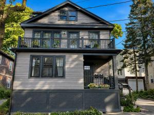 a house with a balcony on top of it at Elegant Cambridge Room, Short Walk to Harvard in Cambridge